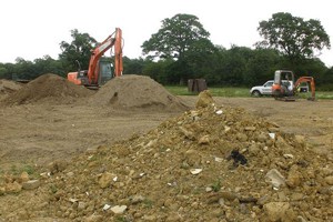 Piles of soil and screening fines by the River Beult
